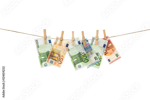 Euro banknotes hanging on clothesline on white background.