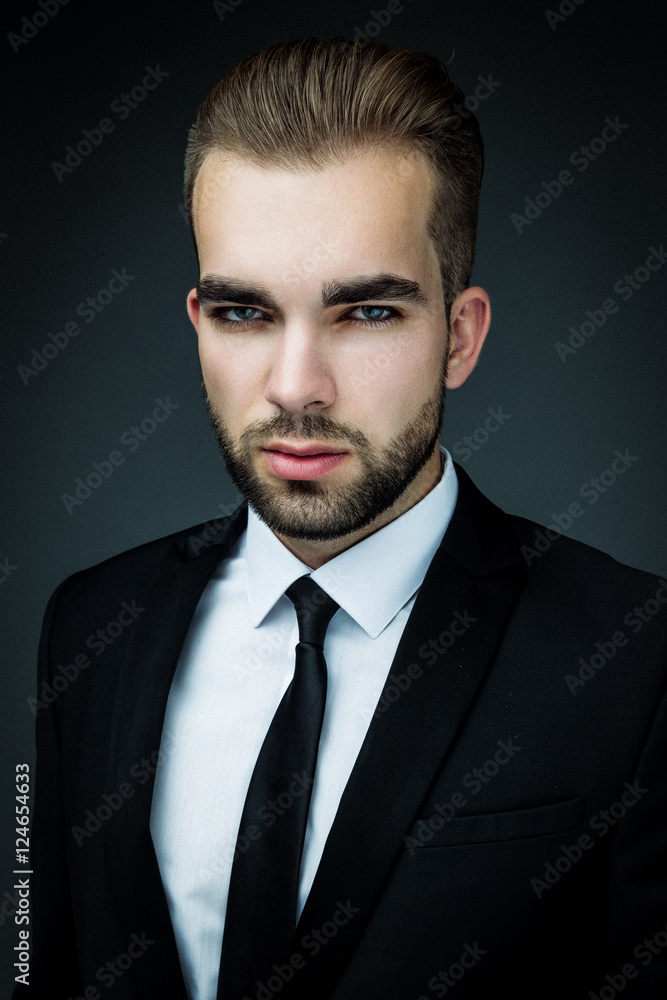 Handsome bearded man wearing suit, portrait shot in studio Handsome bearded man wearing suit, portrait shot in studio