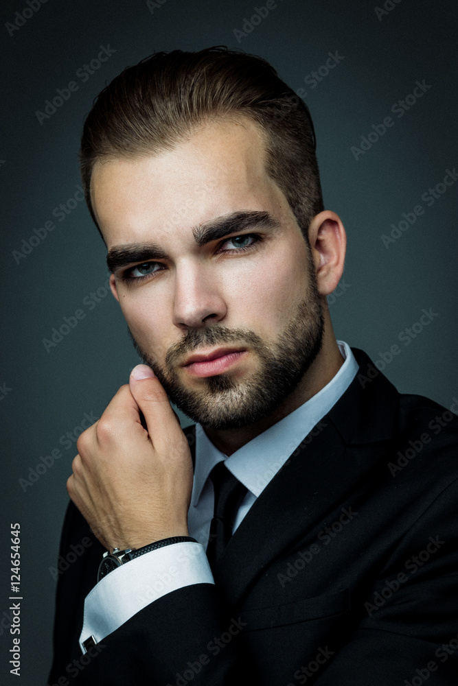 Handsome bearded man wearing suit, portrait shot in studio Handsome bearded man wearing suit, portrait shot in studio