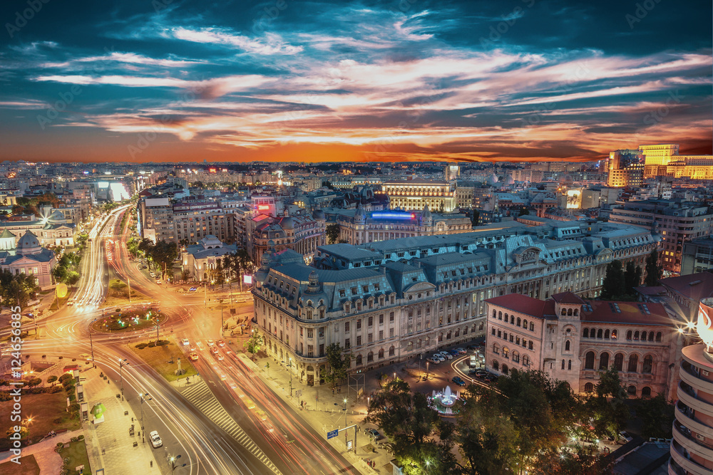 Aerial view of capital city Bucharest, Romania. University Square at sunset with traffic lights.