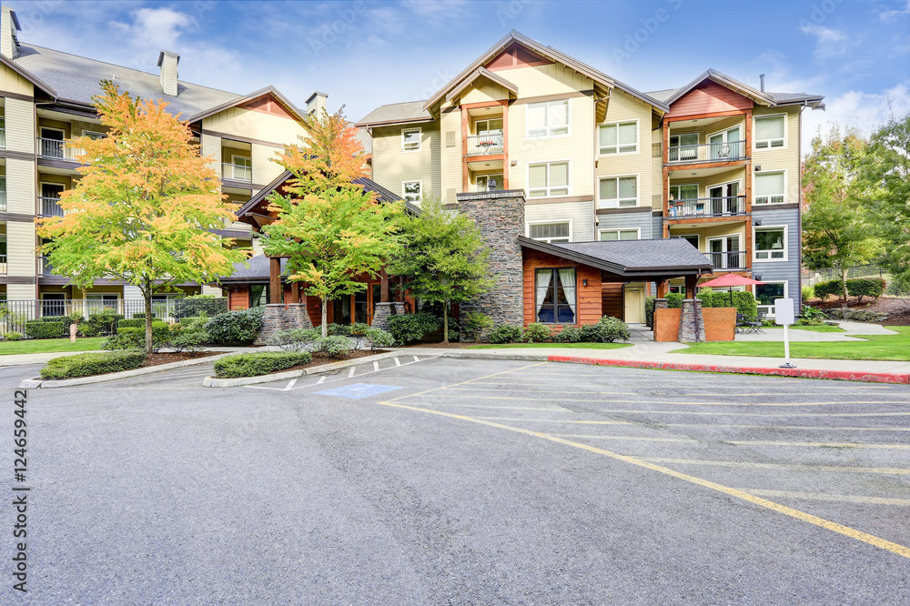 View of modern apartment building with parking area