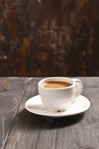 Espresso cup on the wooden table.