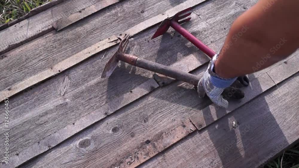 Garden tools on the boards. Hoes to work in the garden. The daytime. Video with sound. Color image FullHD. System PAL Garden tools on the boards. Hoes to work in the garden. The daytime. Video with sound. Color image FullHD. System PAL