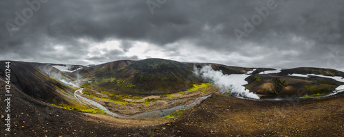 Dark Iceland landscape with green moss and steaming geothermal hot water, Iceland