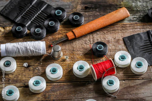 set of sewing threads and accessories on wooden background