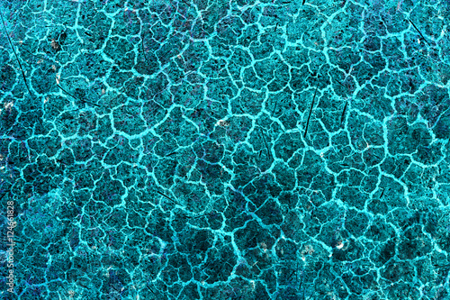 Cracked and peeling paint on the blue wall. Close-up view. Grunge old texture. Abstract background. Vintage style. Scratched and chipped surface.