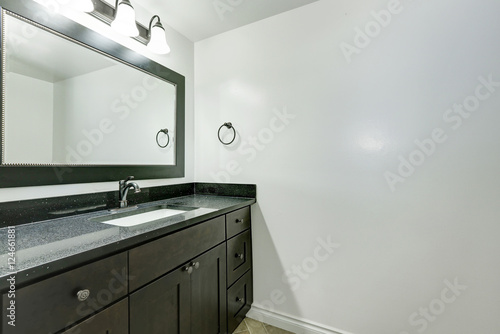 Bathroom vanity in black color in empty apartment