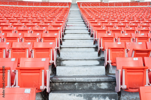 Empty orange seats at stadium,Rows of seat on a soccer stadium © rawintanpin