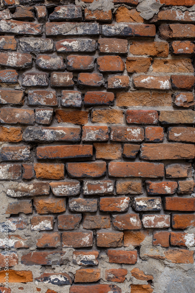 Naklejka premium Old wall of red brick. Background, pattern, texture, vertical shot