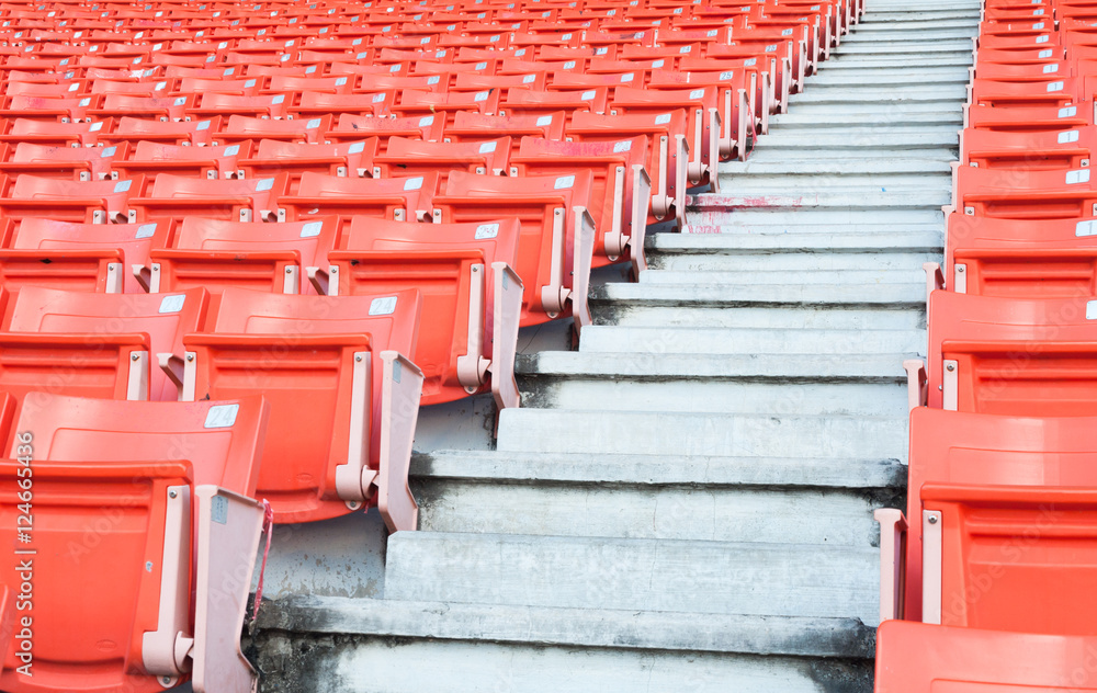 Fototapeta premium Empty orange seats at stadium,Rows of seat on a soccer stadium