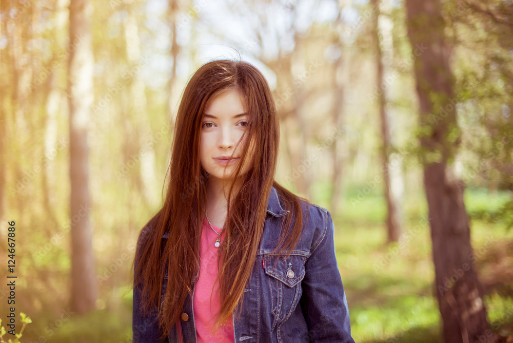 Portrait of a girl with long straight brown hair, which fly in t Portrait of a girl with long straight brown hair, which fly in t