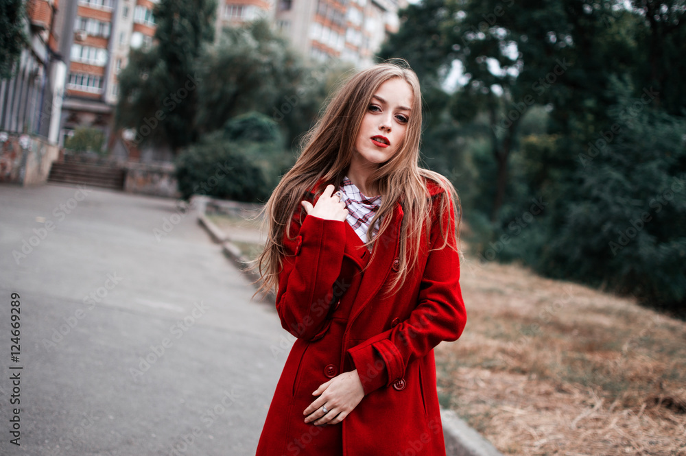 Fototapeta premium portrait of beautiful girl with blue eyes in red