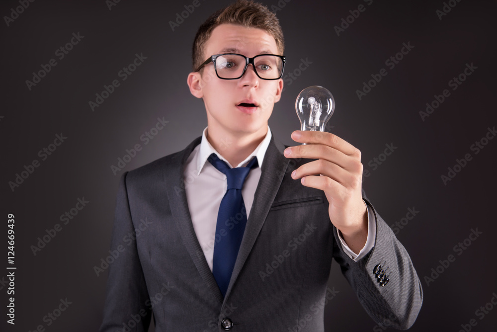 Young businessman with light bulb in idea concept Young businessman with light bulb in idea concept