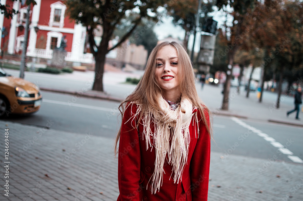 Fototapeta premium portrait of beautiful girl with blue eyes in red