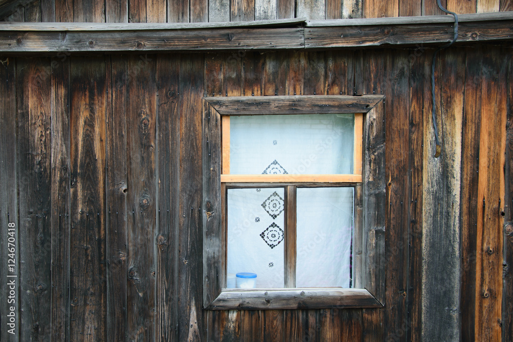 old window of a house made of wooden planks