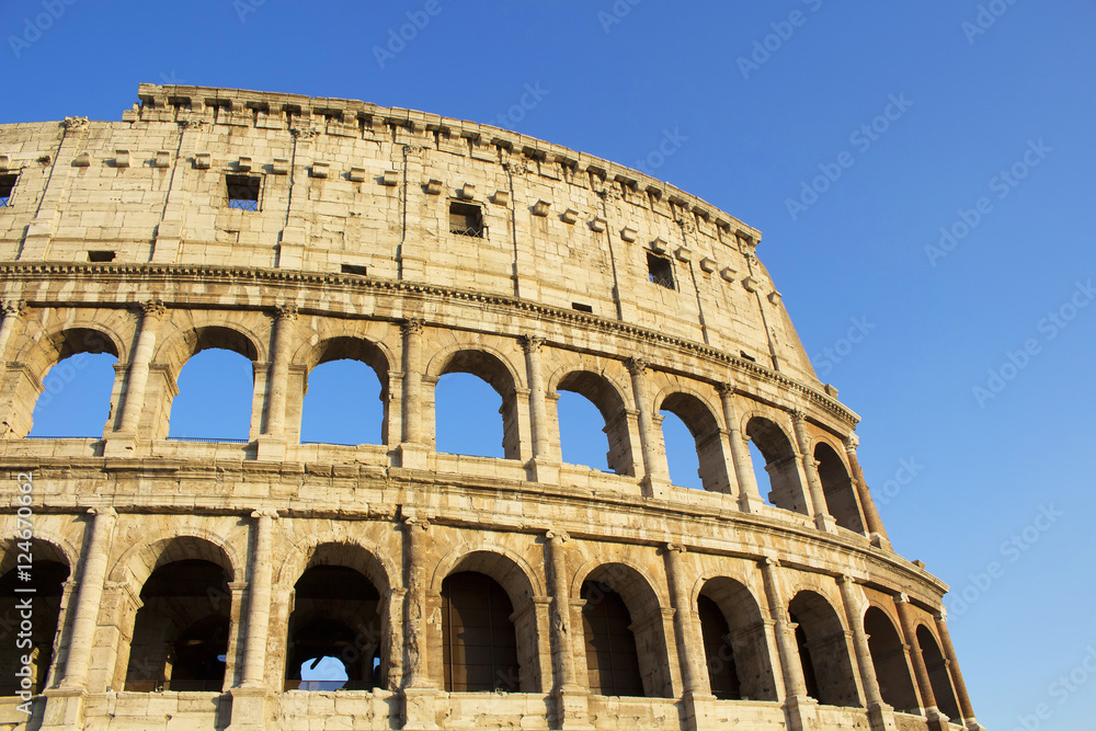 Close up view of Colosseum in Rome. Monumental 3-tiered Roman amphitheater once used for gladiatorial games, with guided tour option