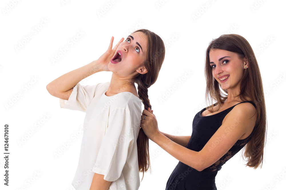 One woman making another one a plait One woman making another one a plait