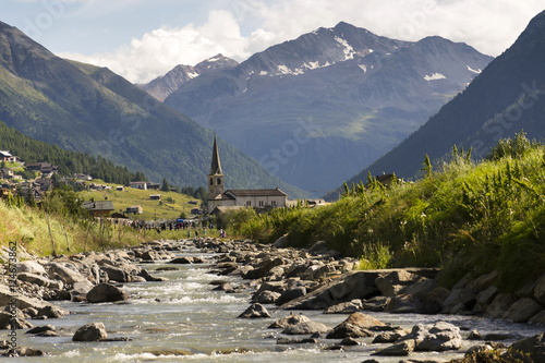 Spol river with church of Santa Maria in Livigno, Italy photo