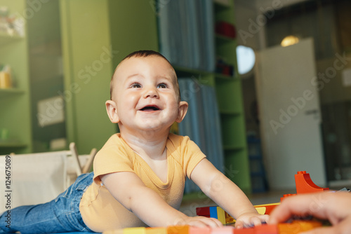 Child boy and mother playing.