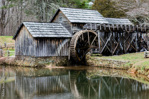 Historic mill house with water wheel and pond.  