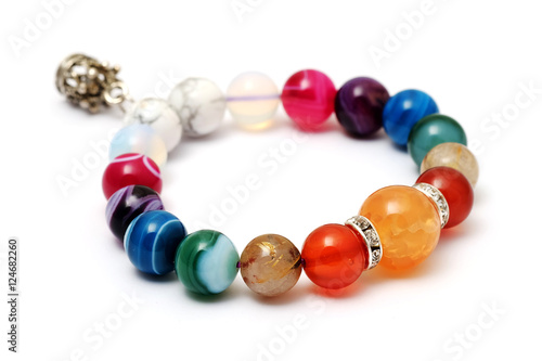 Colorful of agate,jasper bracelet decorate with silver crown pendant with white isolated background