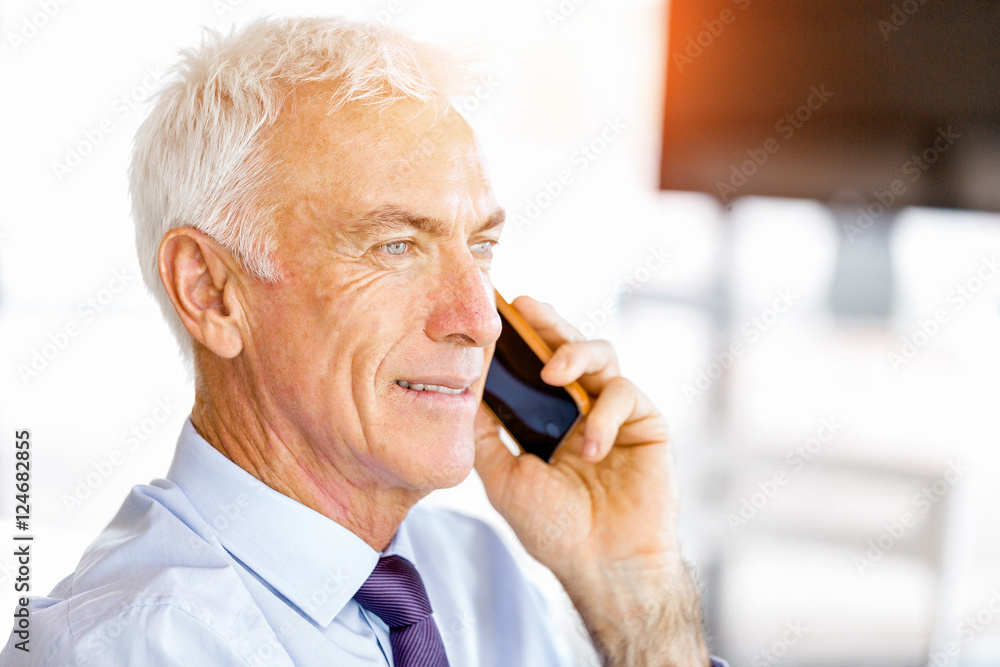 Businessman at the office with mobile phone Businessman at the office with mobile phone