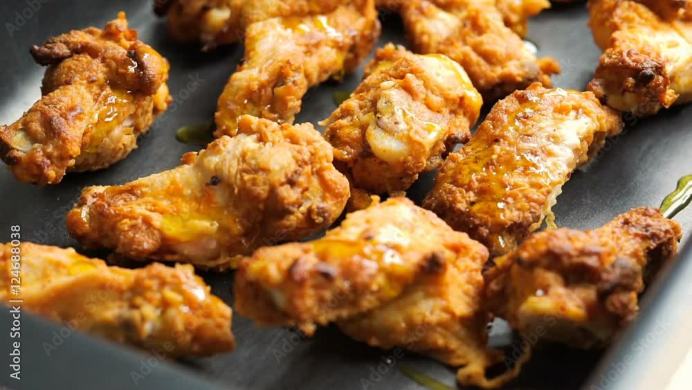 olive oil put on chicken wings on a baking tray before cooking olive oil put on chicken wings on a baking tray before cooking