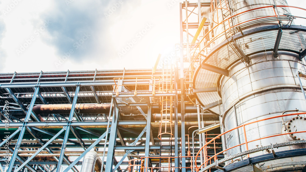 Fototapeta premium Industrial zone,The equipment of oil refining,Close-up of industrial pipelines of an oil-refinery plant.