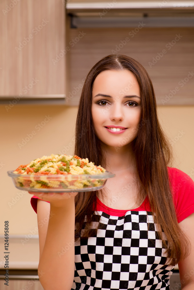 Young woman housewife working in the kitchen