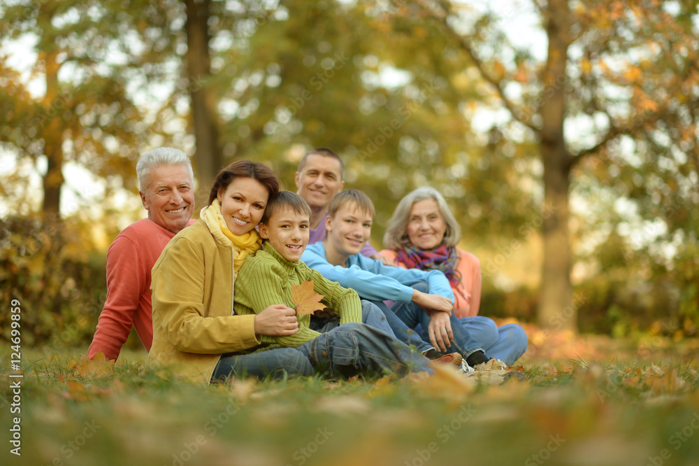 Family relaxing in autumn park