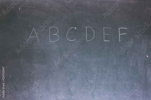 Blackboard with the first letters of the alphabet written on it