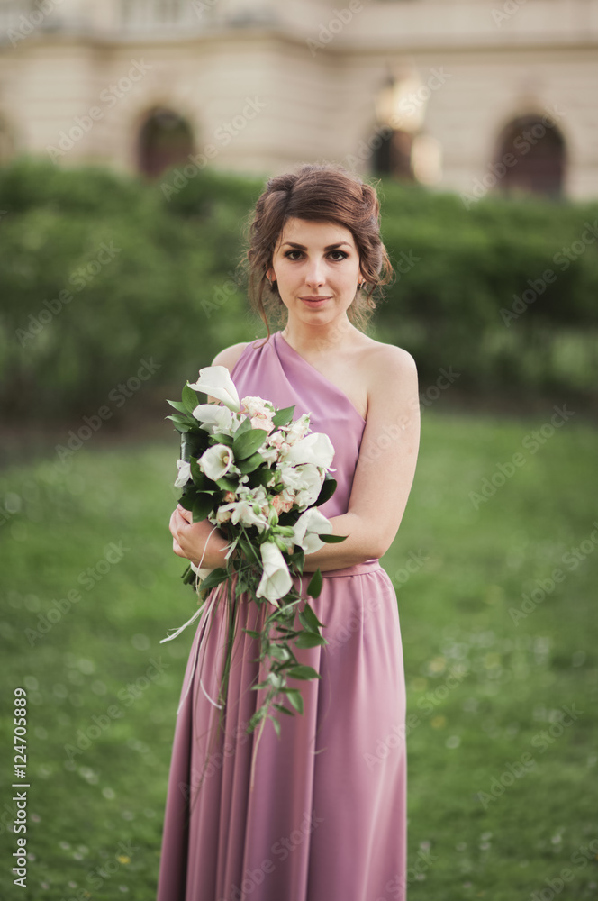 Beautiful bride, girl outdoors posing with bouquet Beautiful bride, girl outdoors posing with bouquet