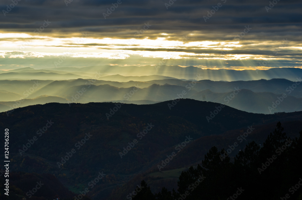 Rolling hills and mountains at autumn sunset, view from Bobija mountain, west Serbia