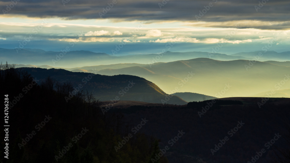 Rolling hills and mountains at autumn sunset, view from Bobija mountain, west Serbia