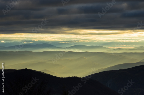 Rolling hills and mountains at autumn sunset, view from Bobija mountain, west Serbia