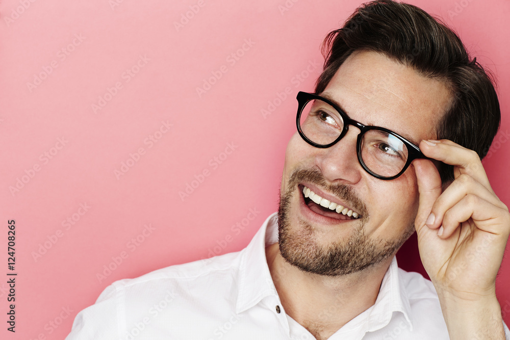 Happy man in spectacles looking away Happy man in spectacles looking away