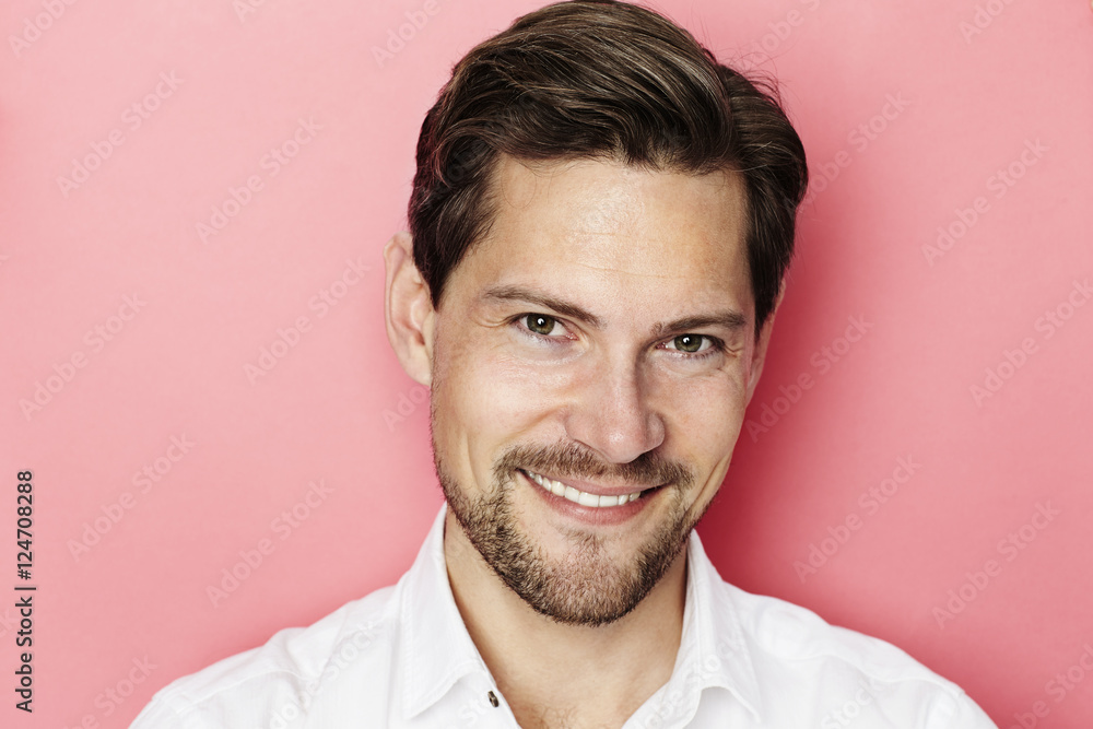 Confident smiling guy in pink studio Confident smiling guy in pink studio