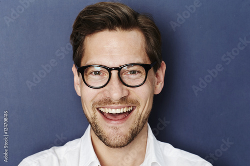 Happy glasses guy in blue studio © sanneberg