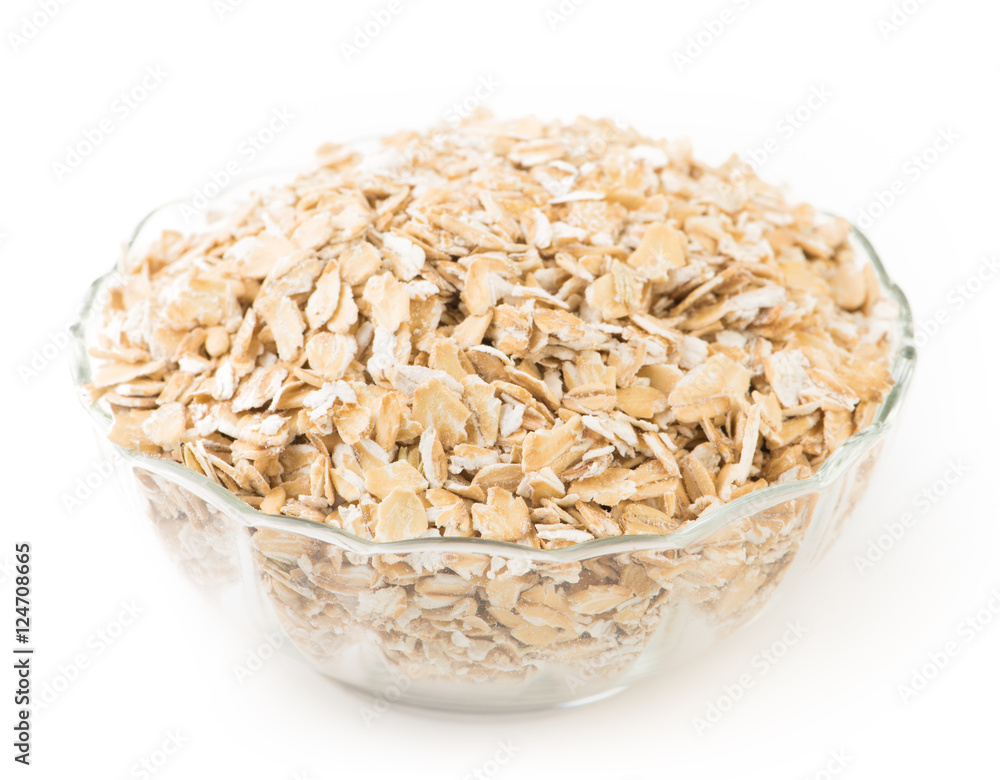 Oat flakes in a glass bowl isolated on white background. Oat flakes in a glass bowl isolated on white background.