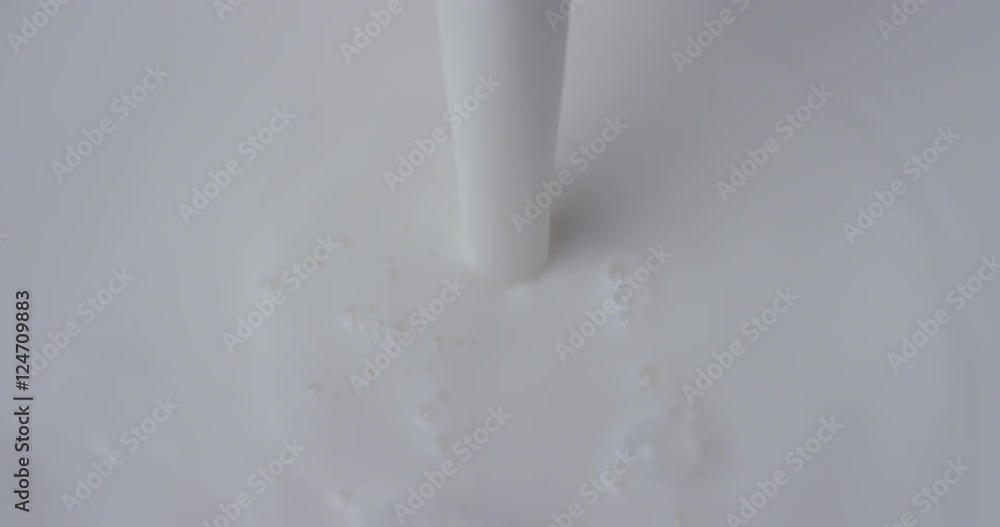Super slow motion macro of milk drops pouring in the bowl (close up) 4k Super slow motion macro of milk drops pouring in the bowl (close up) 4k