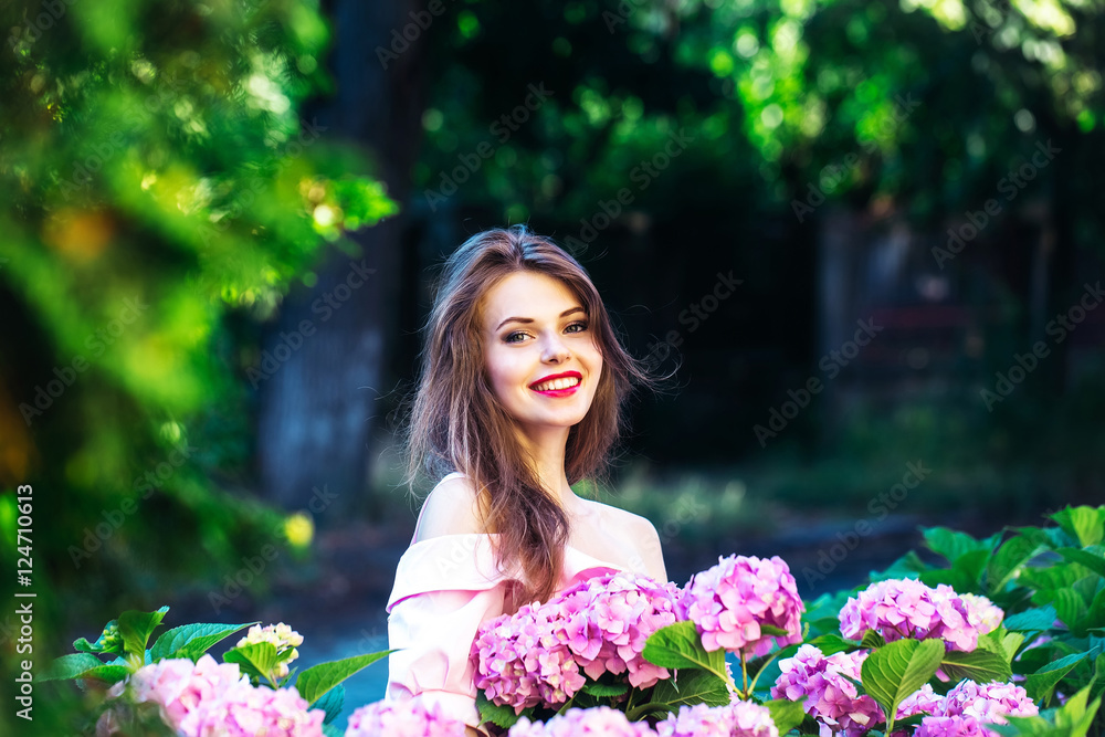 pretty smiling girl in hydrangea flowers pretty smiling girl in hydrangea flowers
