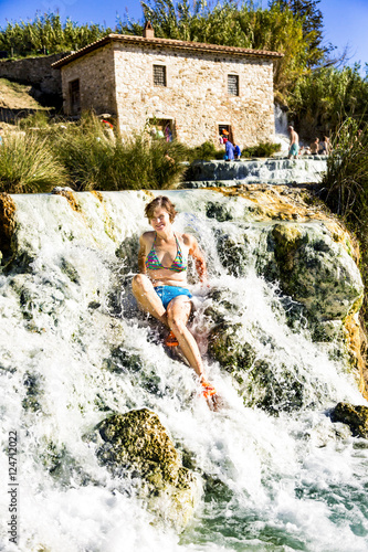 Woman in the natural spa of Saturnia in Tuscany photo