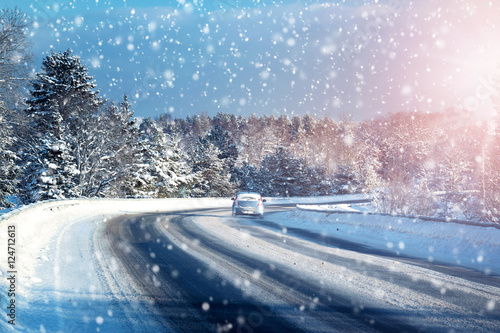 Car tires on winter road covered with snow