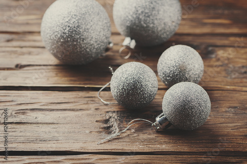 Christmas card with silver balls on the wooden table