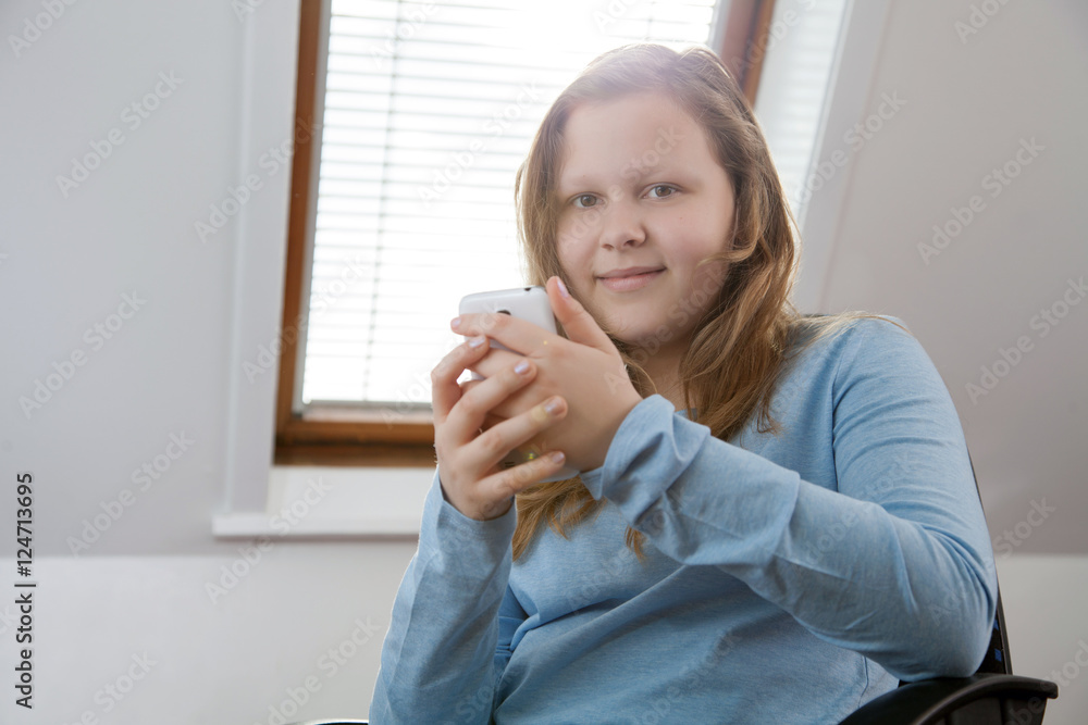 girl texting on smartphone and looking at the camera girl texting on smartphone and looking at the camera