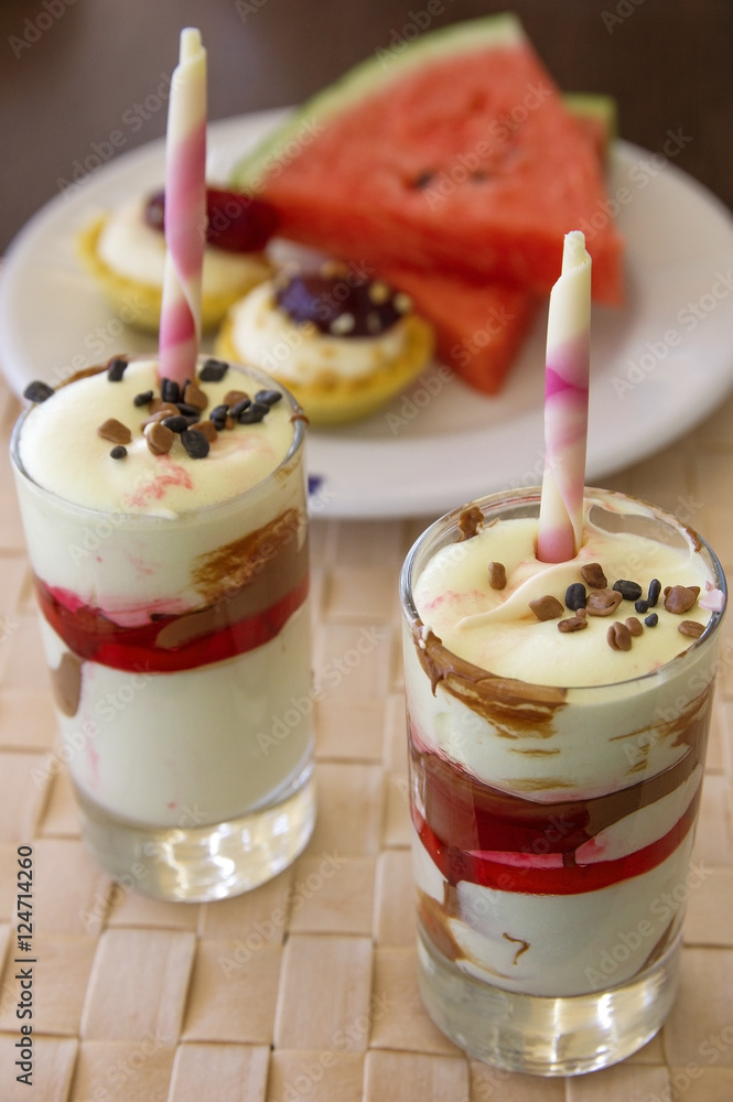 Sweet dessert, cake, watermelon slices on wicker napkin Sweet dessert, cake, watermelon slices on wicker napkin