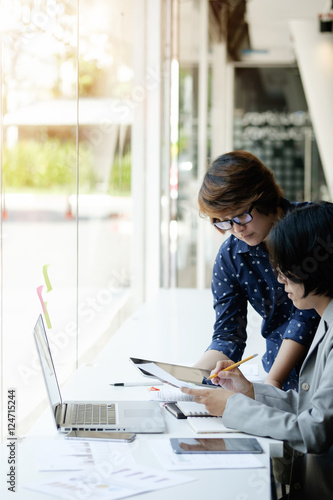 Young businesswoman and her team working together in office, Teamwork Concept. photo