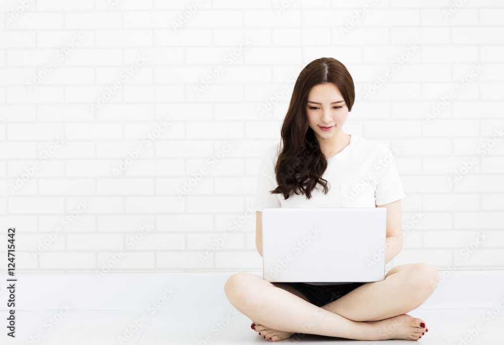 young woman sitting on the floor with laptop young woman sitting on the floor with laptop