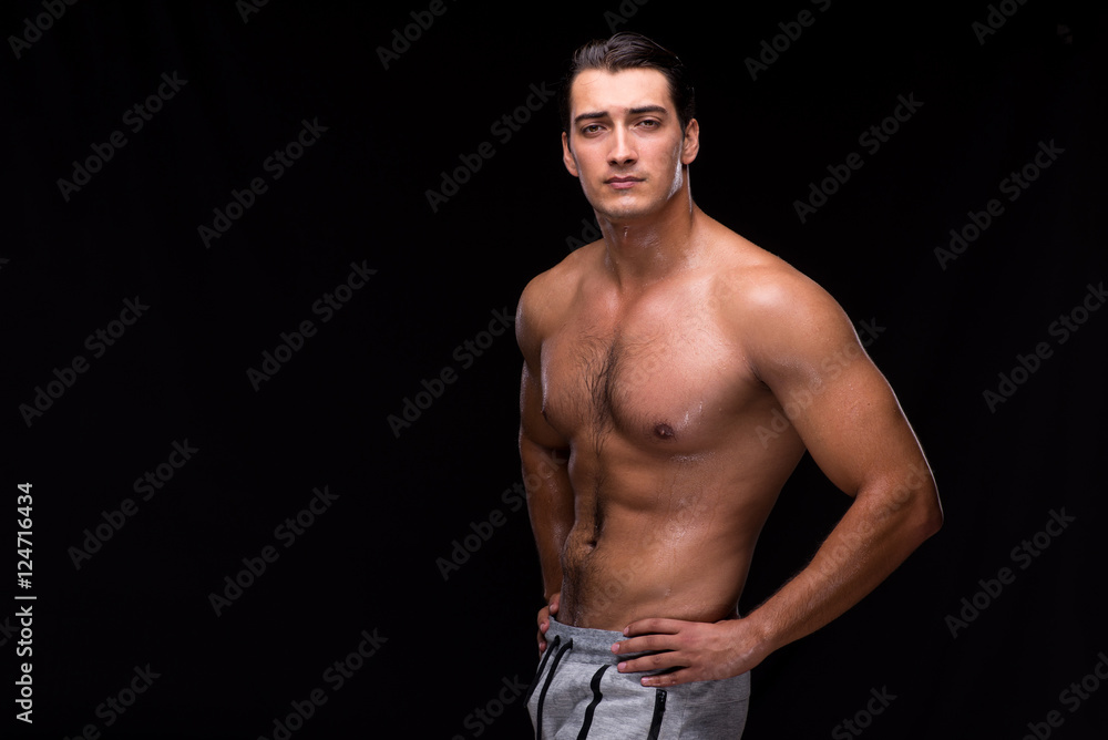 Fototapeta premium Ripped muscular man on black background