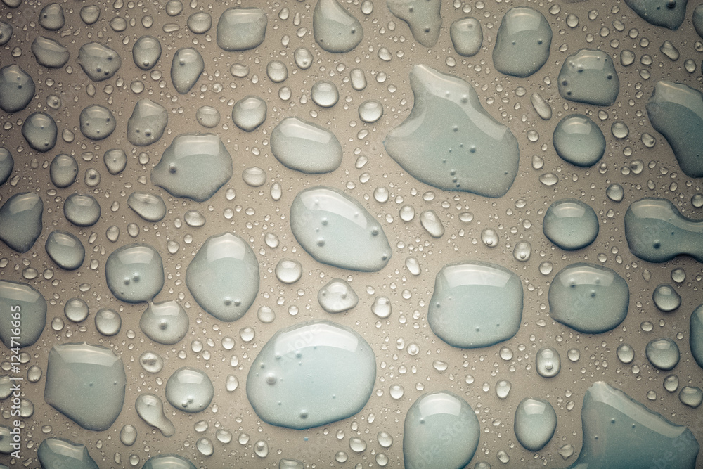 Drops of water on a color background. Gray. Shallow depth of fie Drops of water on a color background. Gray. Shallow depth of fie